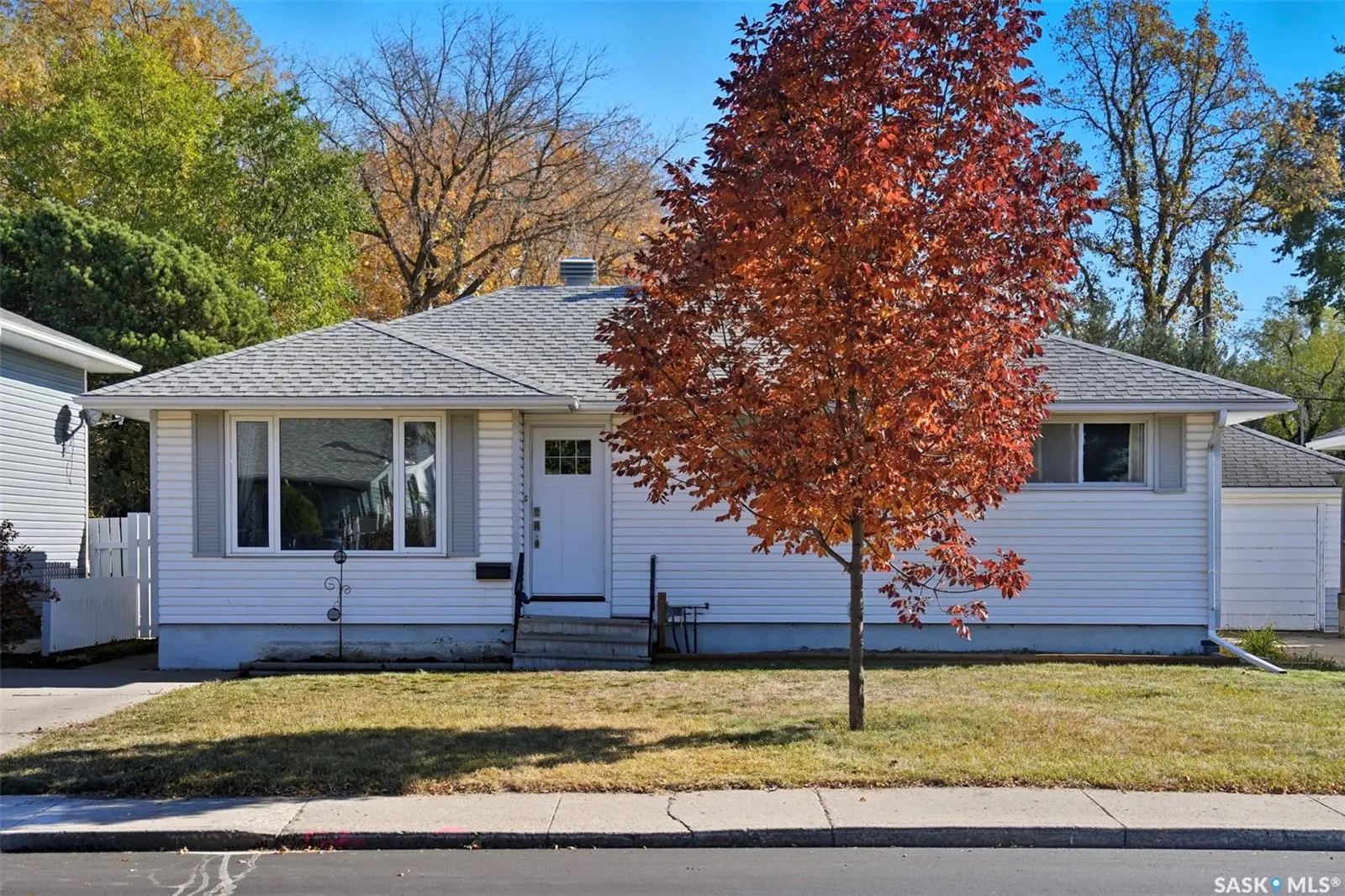 Exterior photo of 2615 Haultain Avenue, Saskatoon SK showing a charming bungalow with a front yard and mature trees